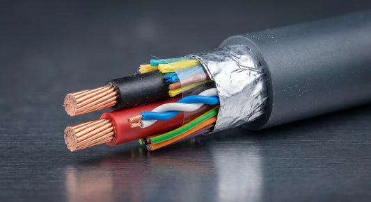 A detailed macro photograph of a precision-cut hybrid cable end, sharply focused against a dark, slightly metallic brushed-aluminum background.
