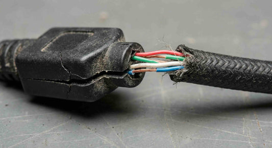 A broken cable due to strain relief failure