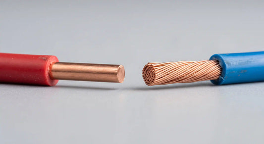 A side-by-side macro comparison showing the cross-section of a solid copper wire with a single core versus a stranded wire composed of multiple twisted strands.