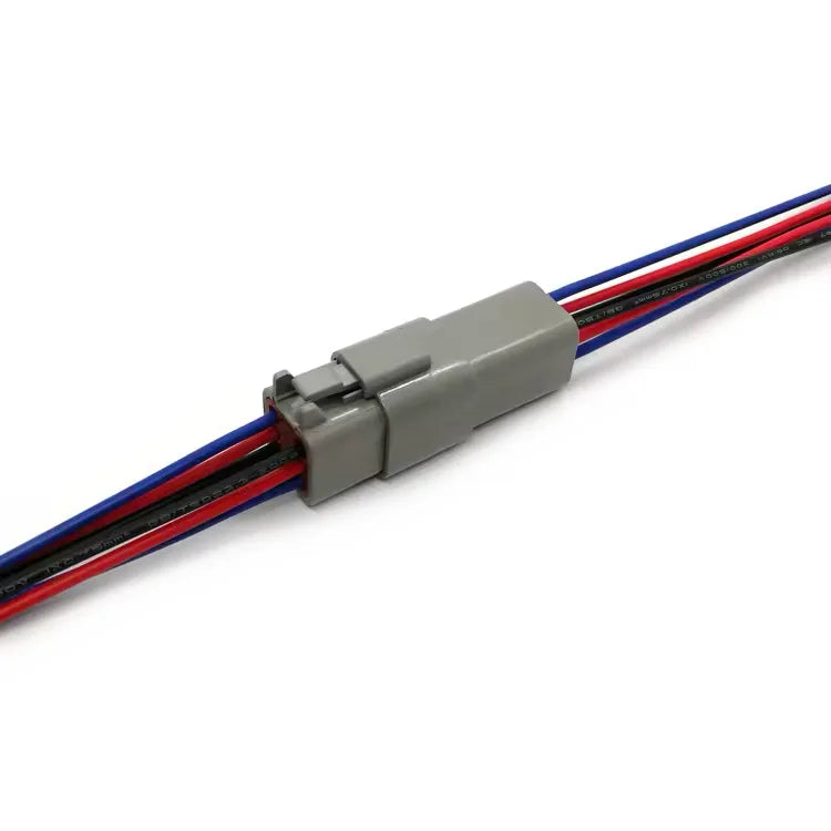6-pin Deutsch DT harness on off-highway diesel engine wiring, sealed against washdown and vibration.