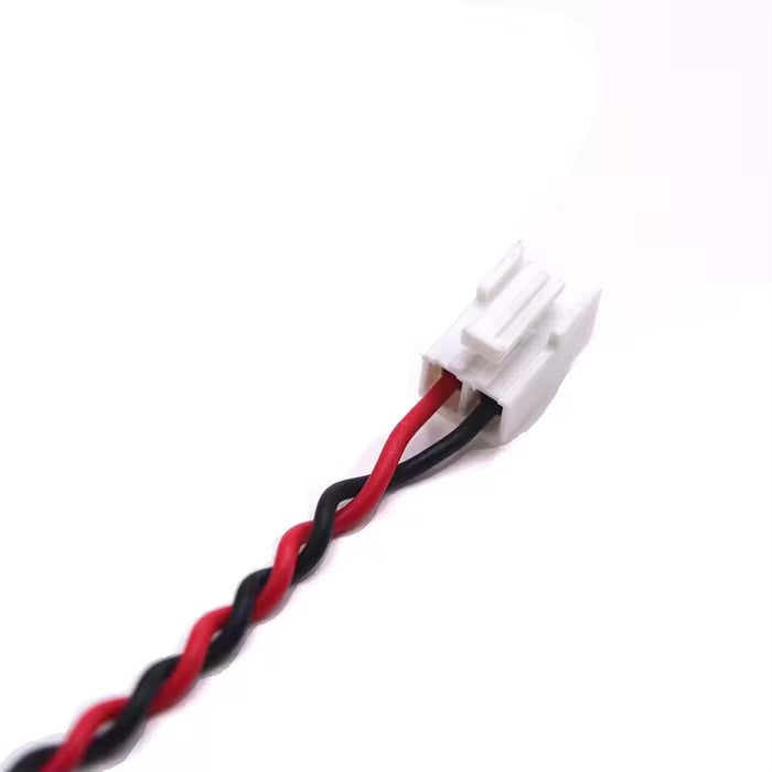 Macro view of a JST 1.0mm pitch connector and red/black twisted pair wiring for a custom battery harness.